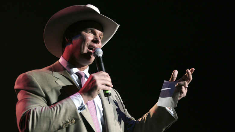 JBL speaks to a crowd during a conference event