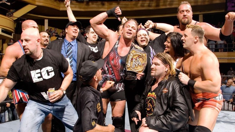 Rob Van Dam poses with the WWE Championship spinner belt, flanked by others in ECW including Paul Heyman, after winning the title from John Cena at ECW One Night Stand.