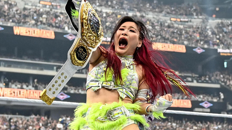 IYO SKY shouts as she holds the WWE Women's World Championship at WrestleMania.
