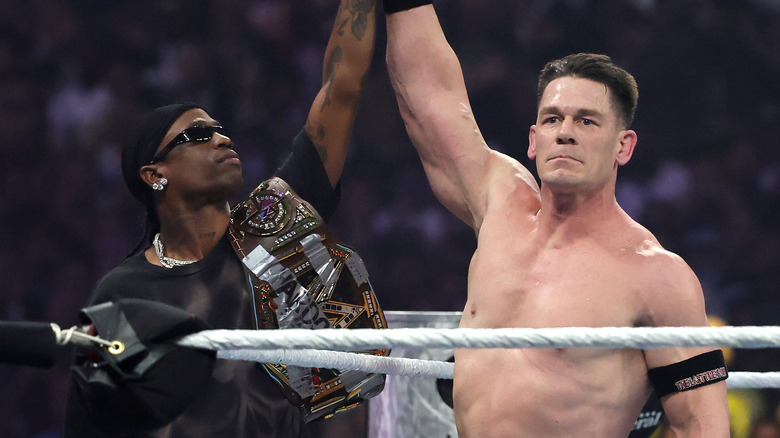 Travis Scott raising John Cena's arm