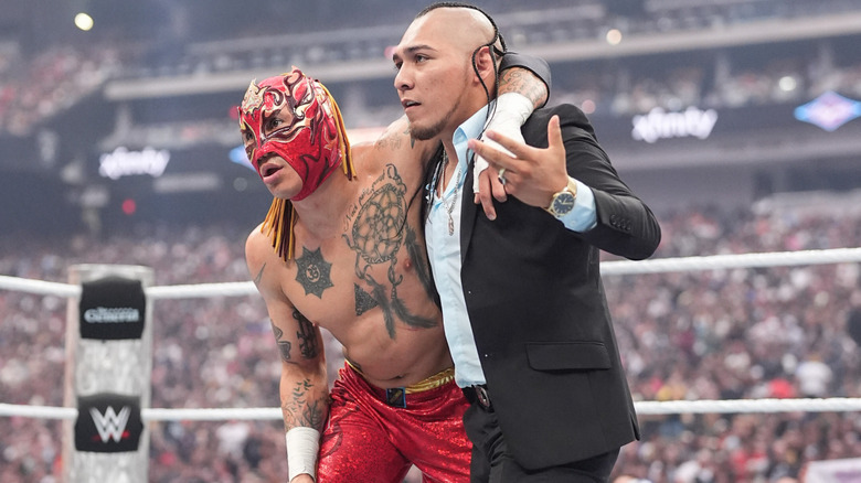 Vikingo assists an injured Rey Fenix