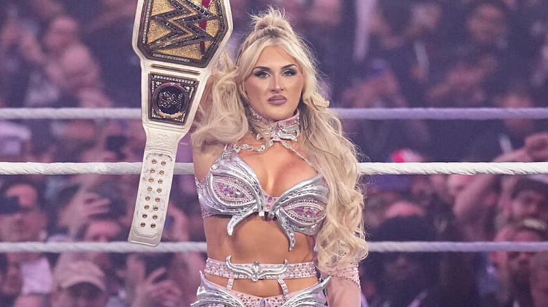 Tiffany Stratton holds up her WWE Women's World Championship during her WrestleMania entrance.