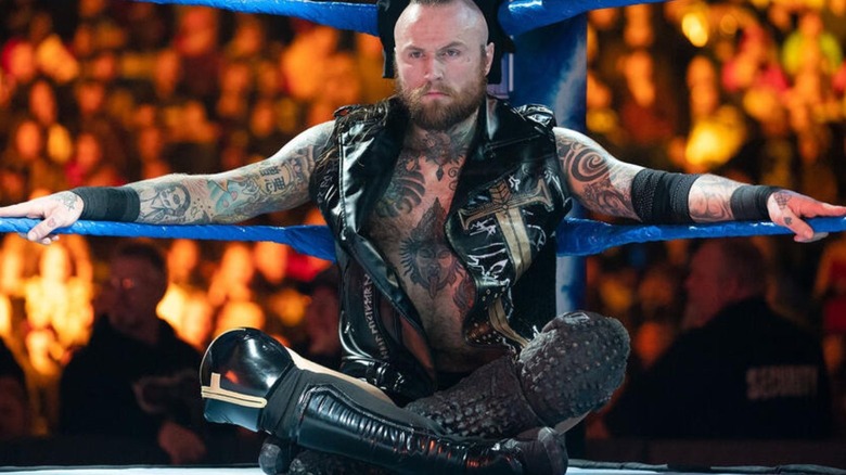 Aleister Black sits in the corner of the ring before a match on "WWE SmackDown."