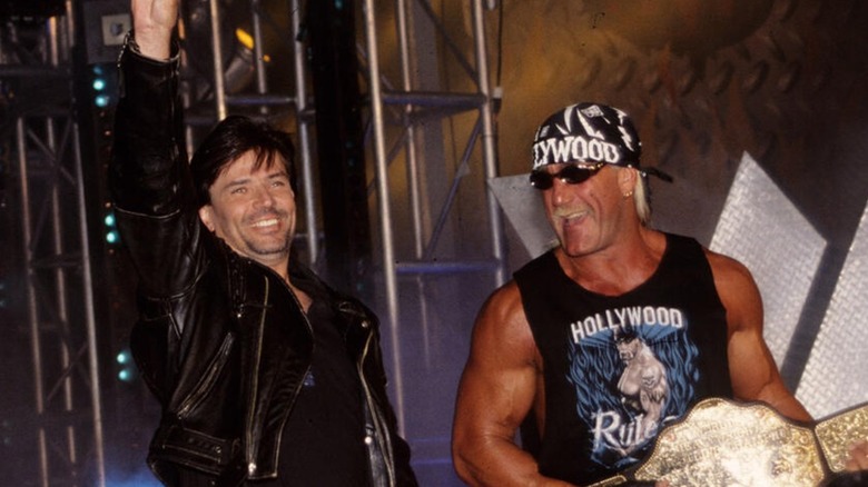 Eric Bischoff and Hulk Hogan making their way to the ring during a WCW show.