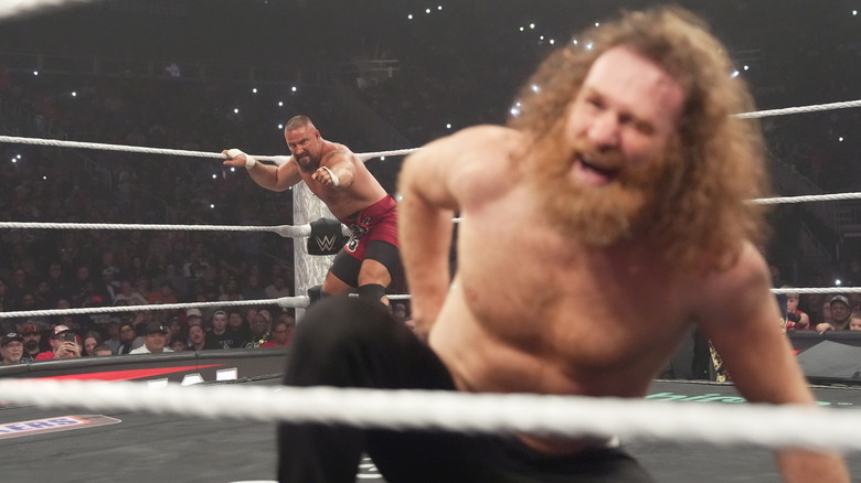 Sami Zayn winces, as Bron Breakker targets him