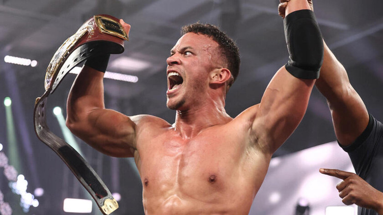 Ricky Saints shouts as he flexes with the NXT North American Championship