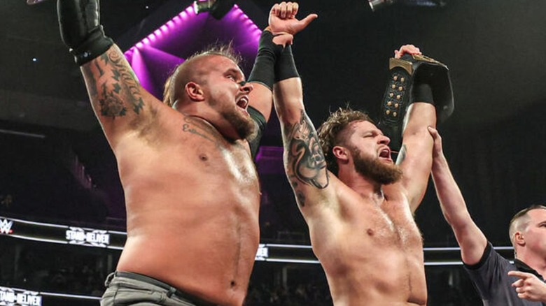 Hank & Tank hold up their newly won NXT Tag Team Championships after defeating FrAxiom at Stand & Deliver.