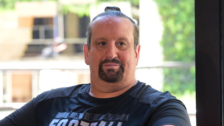 Tommy Dreamer with his hair up in a pony tail
