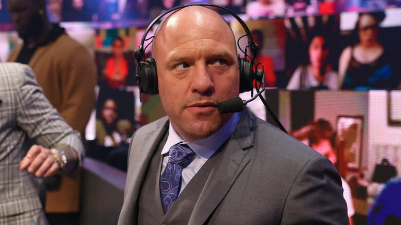Jimmy Smith stands beside Michael Cole behind the commentary desk during WWE's "ThunderDome Era."