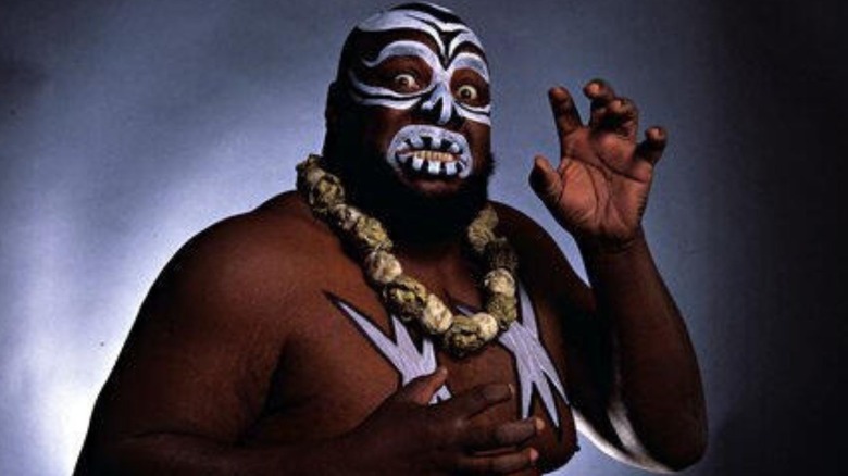 Kamala poses in his face paint for a photoshoot backstage.