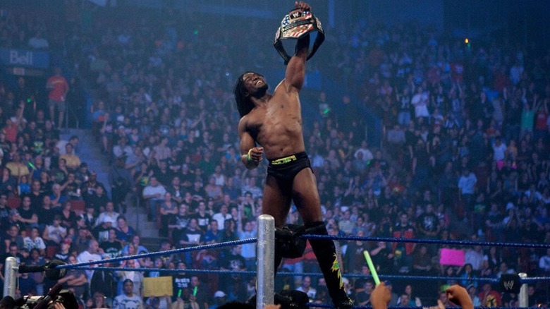 Kofi Kingston celebrates on the turnbuckle, holding up his newly won United States Championship.