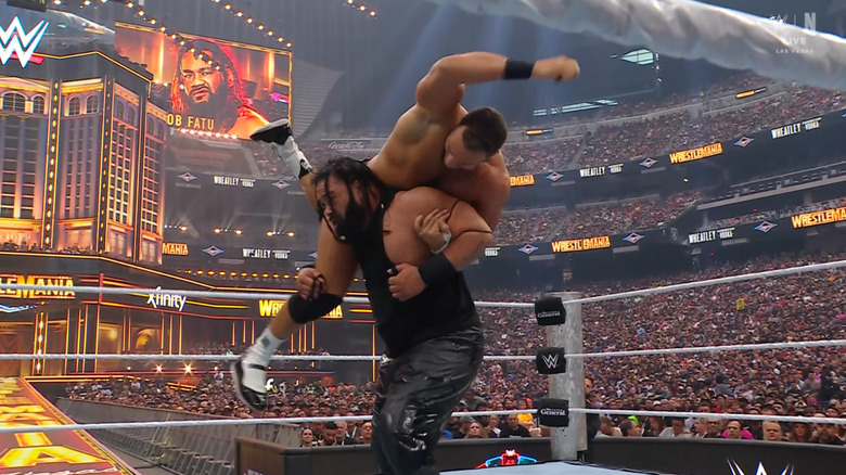 Fatu with Knight on his shoulders