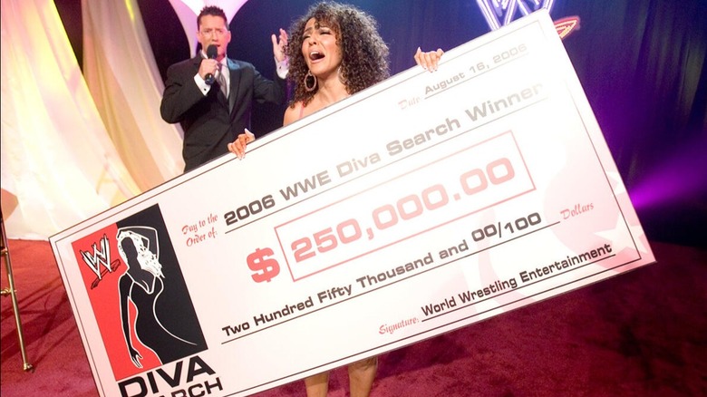 Layla holds up her winning showcase of $250,000 after winning the 2006 WWE Diva Search competition