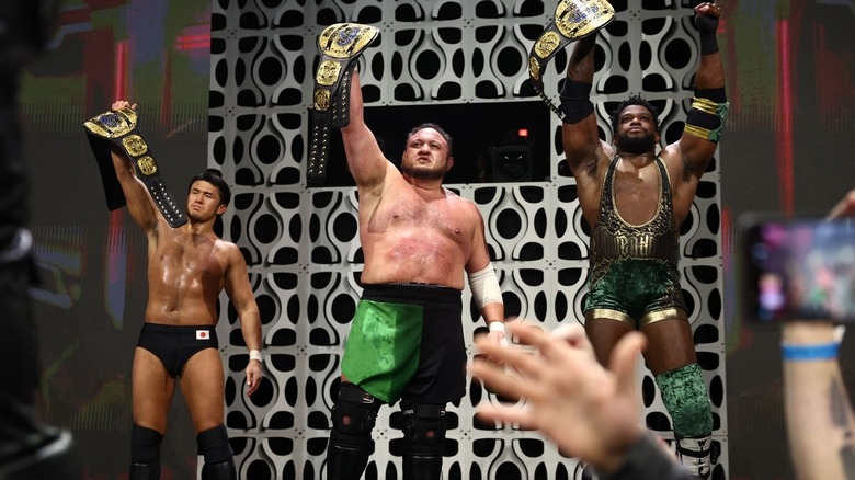 The Opps and Powerhouse Hobbs holding up their new trios titles on "AEW Dynamite"