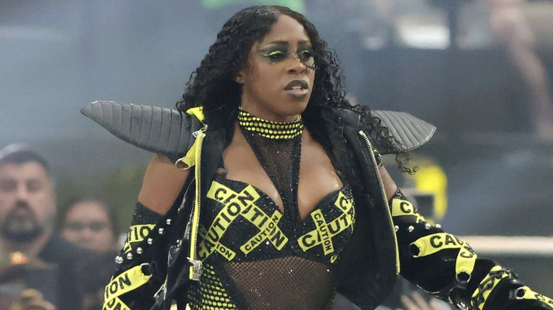 Naomi walks into WrestleMania with her caution tape-inspired gear.