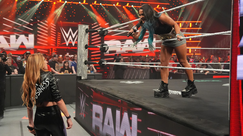 Lyra Valkyria leans out in between the top and middle rope to confront an aghast Becky Lynch during a promo segment.
