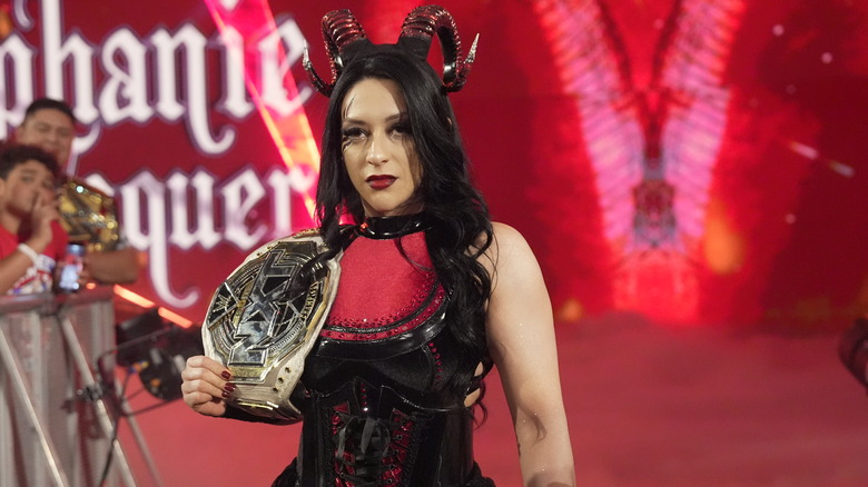 Stephanie Vaquer makes a stoic entrance as she holds the "NXT" Women's Championship.