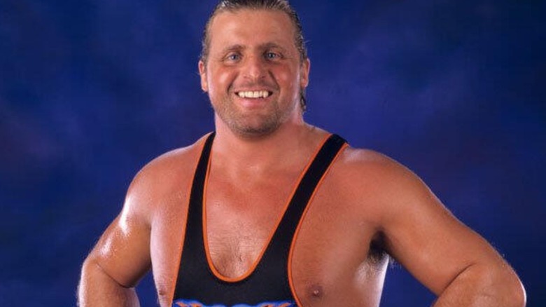 Owen Hart poses backstage wearing the European Championship.