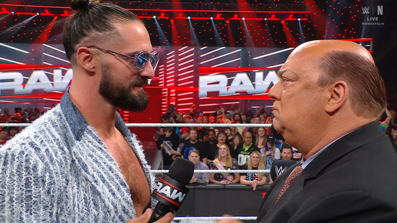 Rollins and Heyman staring each other down in the ring