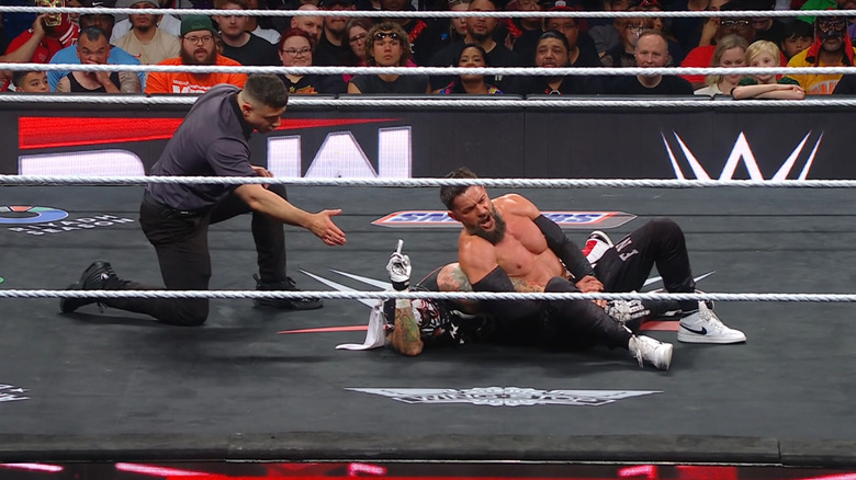 Penta with a submission locked in on Balor