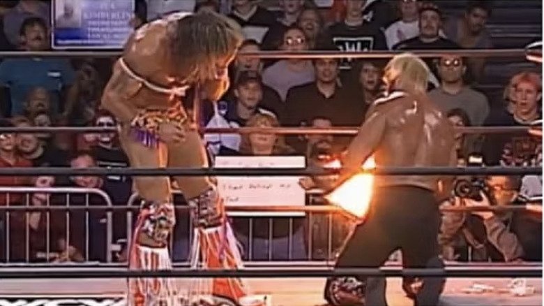 Hollywood Hogan tries to throw flash paper at The Warrior to no avail.