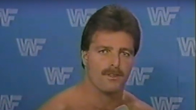 Raymond Rougeau speaking in a backstage segment
