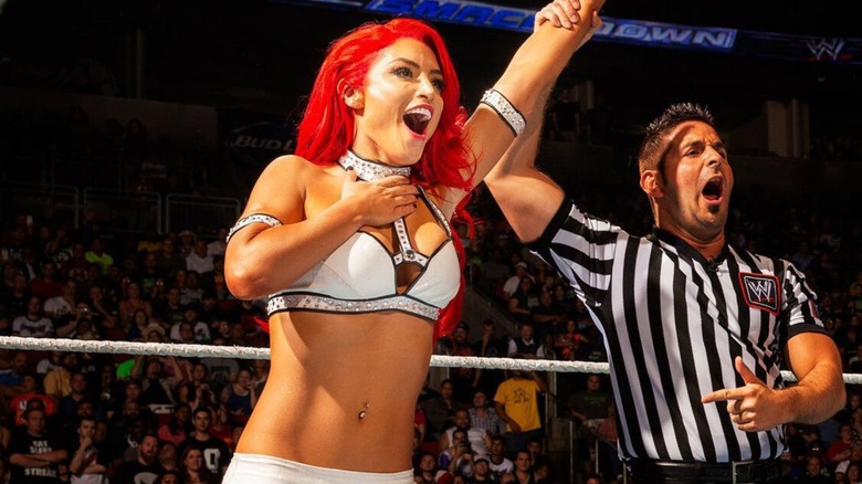 Eva Marie has her hand raised by a referee following a victory on "WWE SmackDown."