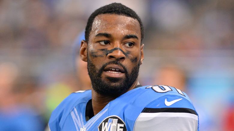 Calvin Johnsin wearing a Detroit Lions jersey and football pads