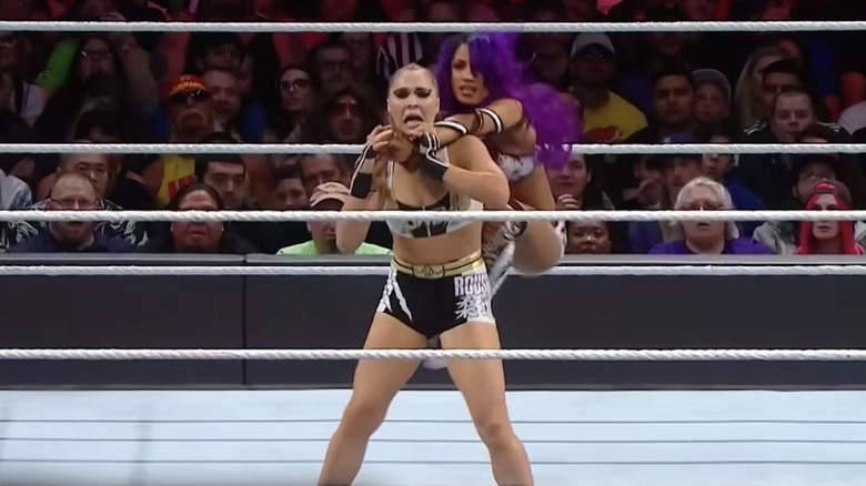 Sasha Banks on Ronda Rousey's back