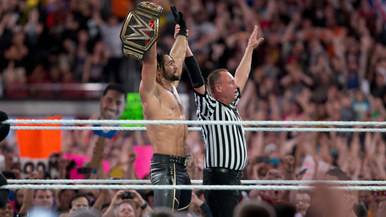 Referee raising Seth Rollins' hand