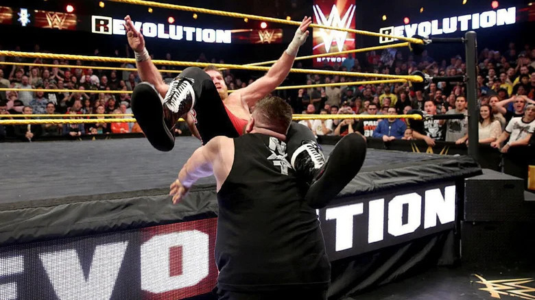 Kevin Owens powerbombs Sami Zayn on the ring apron to close NXT Takeover: R Evolution