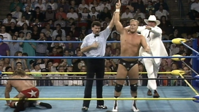 Steve Austin celebrating after defeating Brian Pillman