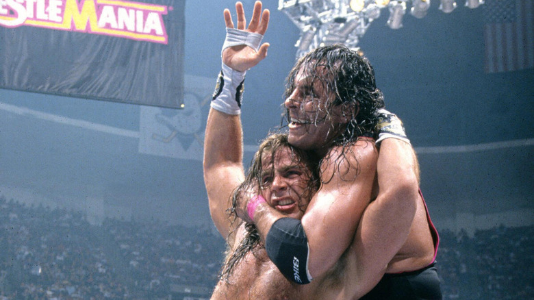 Bret Hart chokes out a flailing Shawn Michaels.
