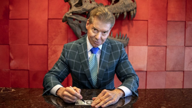 Vince McMahon smirks in dastardly fashion