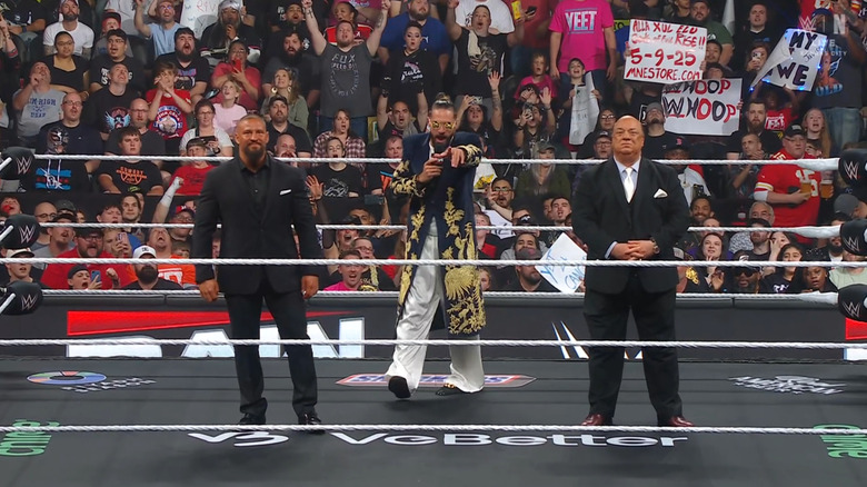 Breakker, Rollins, and Heyman inside the ring