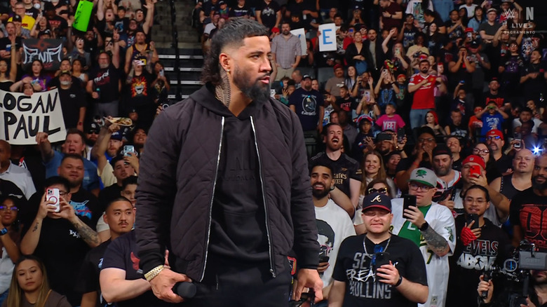 Jey standing on top of the announce desk
