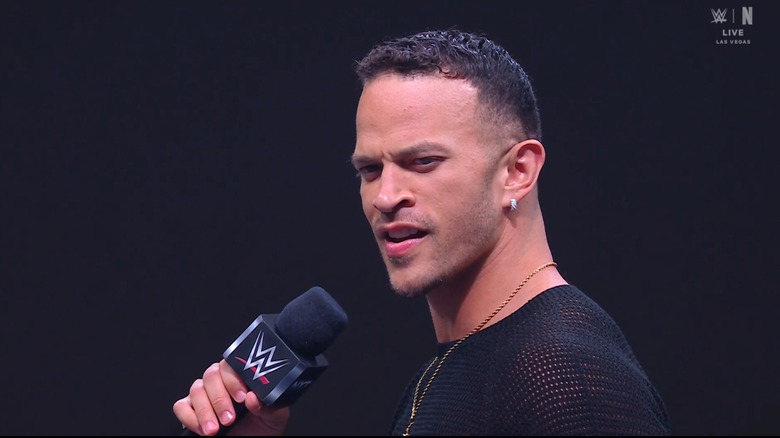 Saints in the ring with a microphone in hand