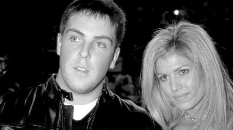 David Flair with Torrie Wilson at his arm.