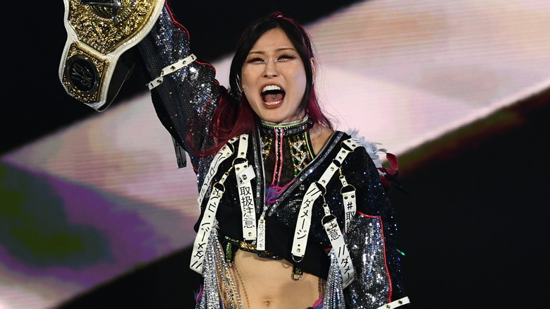 IYO SKY holding up the WWE Women's World Championship
