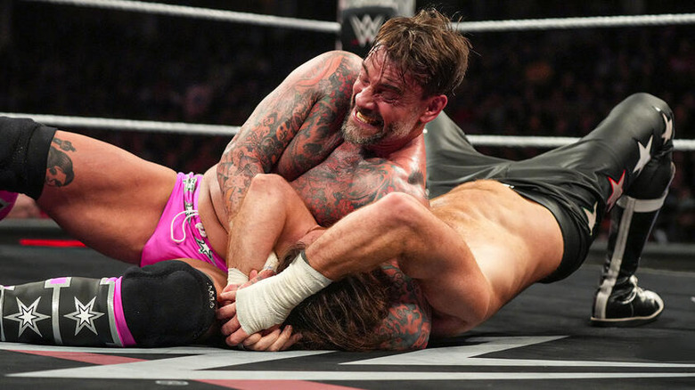 CM Punk grapples with Sami Zayn on the mat on "WWE Raw"