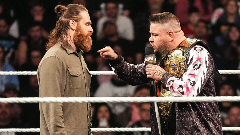 Kevin Owens pointing at Sami Zayn while addressing him on the mic on "WWE Raw."