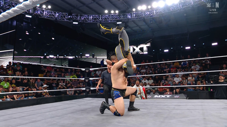 Inamura with Lee in a vertical suplex position